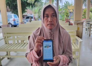 Elok Afifah menunjukkan program REHAB 3.0. (Foto: Dok/Humas BPJS Kesehatan Cabang Jember)