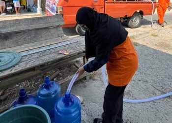Lusyana Zakaria atau biasa disapa Ka Uchee, petugas BPBD Provinsi Gorontalo yang turut turun langsung membantu menyalurkan air bersih untuk masyarakat Desa Tualango, Kecamatan Tilango, Kabupaten Gorontalo, Senin (21/9/2026).